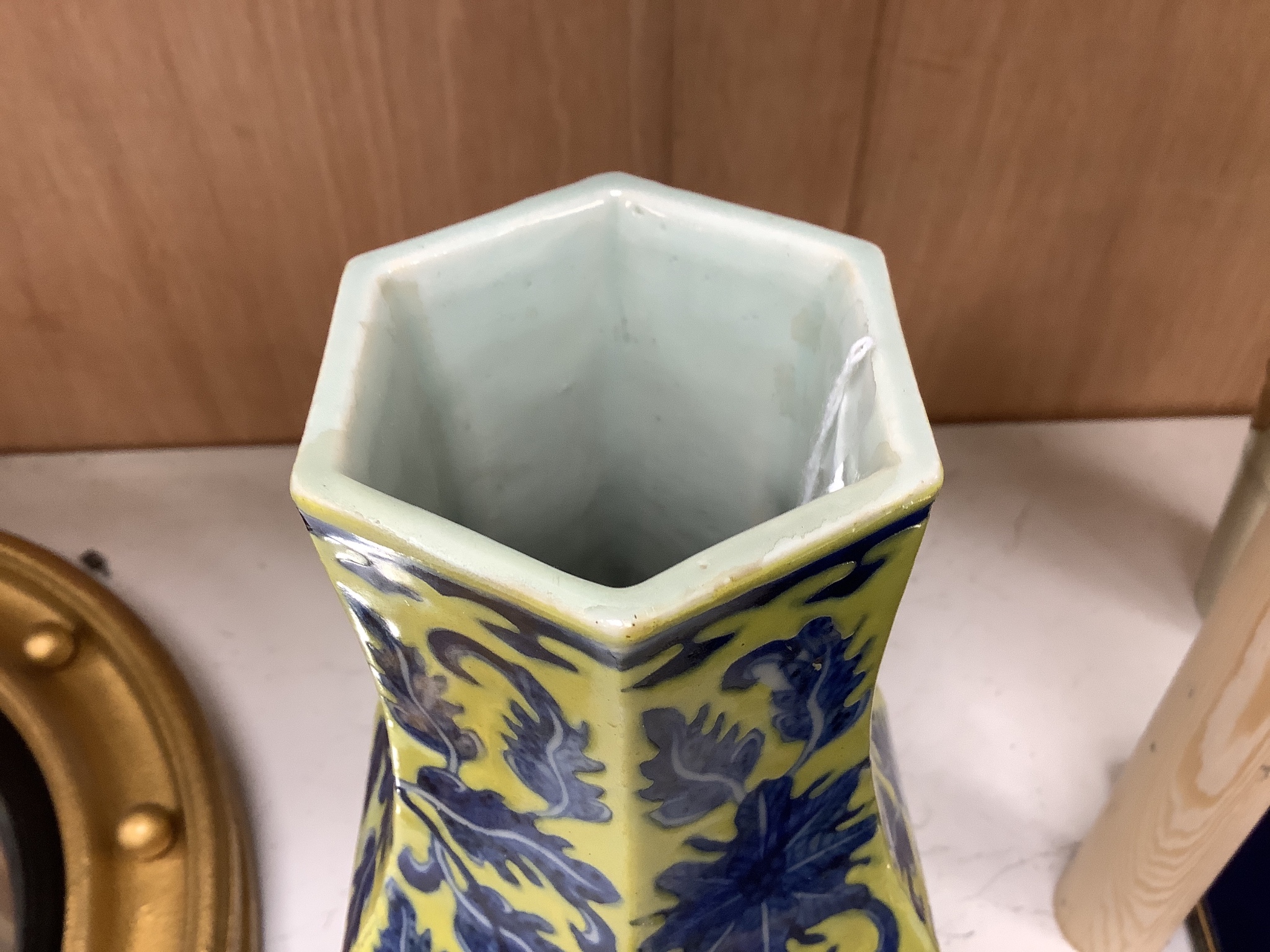 A Chinese underglaze blue yellow ground hexagonal vase, early 20th century, some restoration